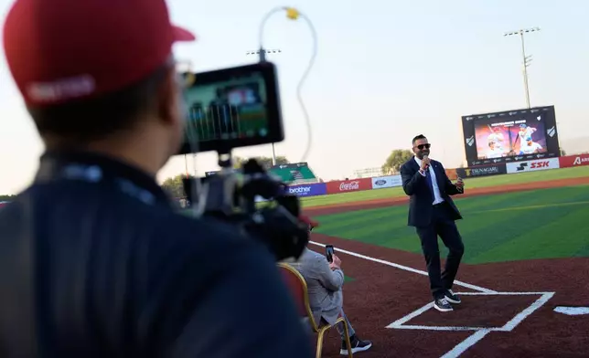 Baseball United CEO and co-founder Kash Shaikh speaks to journalists ahead of the league's inaugural season at the new Barry Larkin Field in Ud al-Bayda outside of Dubai, United Arab Emirates, Thursday, Nov. 13, 2025. (AP Photo/Fatima Shbair)