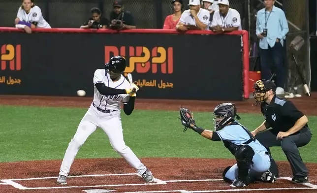 A Mumbai batter hits the ball during the league's opening baseball game against Karachi at the new Barry Larkin Field in Ud al-Bayda on the outskirts of Dubai, United Arab Emirates, Friday, Nov. 14, 2025. (AP Photo/Fatima Shbair)