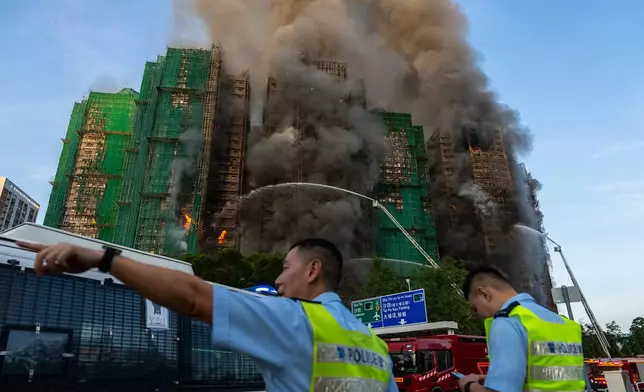 First responders work the scene of a fire at Wang Fuk Court, a residential estate in the Tai Po district of Hong Kong's New Territories on Wednesday, Nov. 26 2025. (AP Photo/Chan Long Hei)