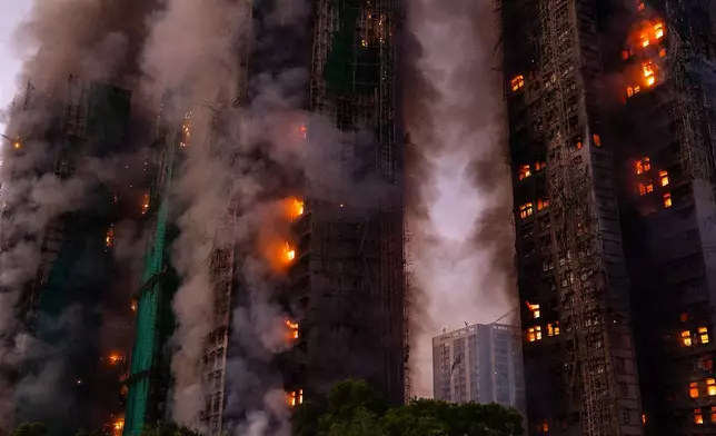 Smoke rises after a fire broke out at Wang Fuk Court, a residential estate in the Tai Po district of Hong Kong's New Territories on Wednesday, Nov. 26 2025. (AP Photo/Chan Long Hei)