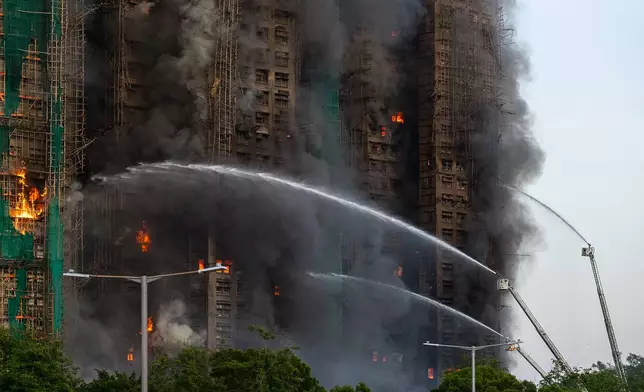First responders work the scene of a fire at Wang Fuk Court, a residential estate in the Tai Po district of Hong Kong's New Territories on Wednesday, Nov. 26 2025. (AP Photo/Chan Long Hei)
