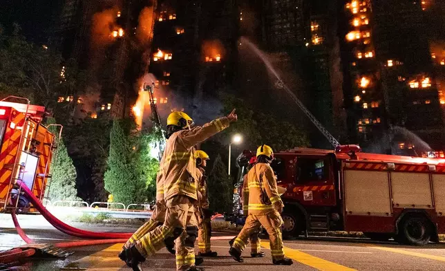 Firefighters work to extinguisha fire that broke out at Wang Fuk Court, a residential estate in the Tai Po district of Hong Kong's New Territories, Wednesday, Nov. 26 2025. (AP Photo/Chan Long Hei)