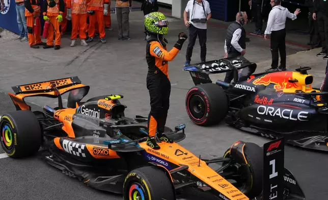 McLaren driver Lando Norris of Britain celebrates finishing first in the Brazilian Formula One Grand Prix at the Interlagos race track in Sao Paulo, Sunday, Nov. 9, 2025. (AP Photo/Andre Penner)