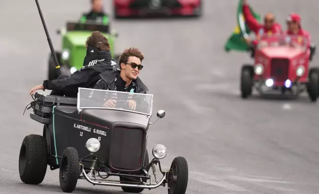 Mercedes driver George Russell of Britain drives during the opening parade at the Brazilian Formula One Grand Prix at the Interlagos race track in Sao Paulo, Sunday, Nov. 9, 2025. (AP Photo/Andre Penner)
