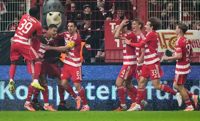 Union's Danilho Doekhi celebrates with team mates after scoring his side's second goal during the Bundesliga soccer match between Union Berlin and FC Bayern Munich in Berlin, Germany, Saturday, Nov. 8, 2025. (AP Photo/Martin Meissner)