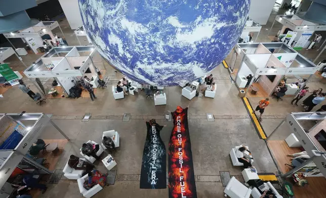 Activists participate in a demonstration to end the use of fossil fuels at the COP30 U.N. Climate Summit, Thursday, Nov. 20, 2025, in Belem, Brazil. (AP Photo/Andre Penner)