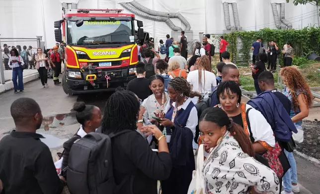 Attendees evacuate after a fire was reported inside the venue for the COP30 U.N. Climate Summit, Thursday, Nov. 20, 2025, in Belem, Brazil. (AP Photo/Joshua A. Bickel)