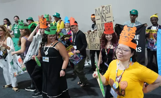 Demonstrators dance during an action for climate justice at the COP30 U.N. Climate Summit, Thursday, Nov. 20, 2025, in Belem, Brazil. (AP Photo/Joshua A. Bickel)