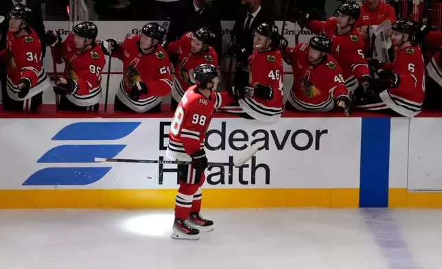Chicago Blackhawks center Connor Bedard (98) celebrates his goal against the Calgary Flames during the third period of an NHL hockey game Tuesday, Nov. 18, 2025, in Chicago. (AP Photo/David Banks)