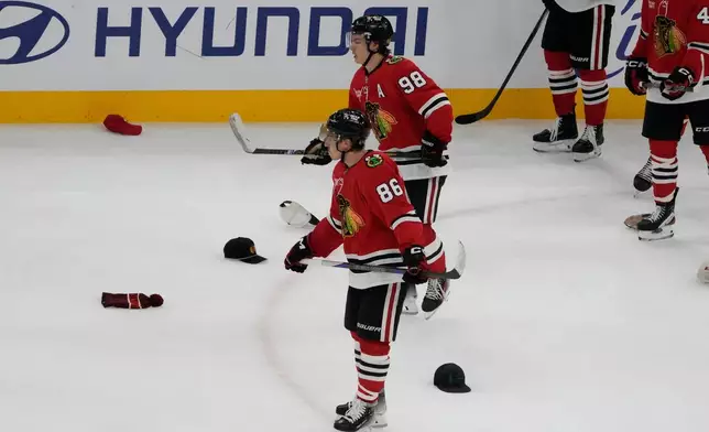 Chicago Blackhawks center Connor Bedard (98) celebrates his hat trick against the Calgary Flames during the third period of an NHL hockey game, Tuesday, Nov. 18, 2025, in Chicago. (AP Photo/David Banks)