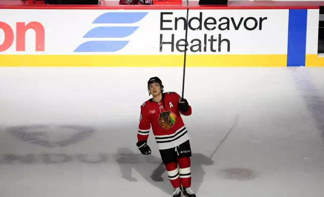 Chicago Blackhawks center Connor Bedard celebrates a win against the Calgary Flames in an NHL hockey game, Tuesday, Nov. 18, 2025, in Chicago. (AP Photo/David Banks)