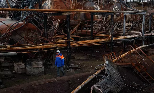 Victor, a Naftogaz worker, walks in front of a Naftogaz gas extraction facility destroyed by a Russian strike in Ukraine, on Tuesday, Nov. 18, 2025. (AP Photo/Evgeniy Maloletka)