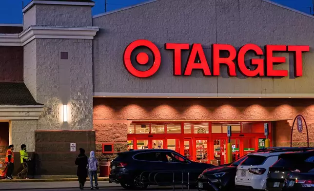 Shoppers walk towards a Target retail store, Tuesday, Nov. 18, 2025, in Salem, N.H. (AP Photo/Charles Krupa)