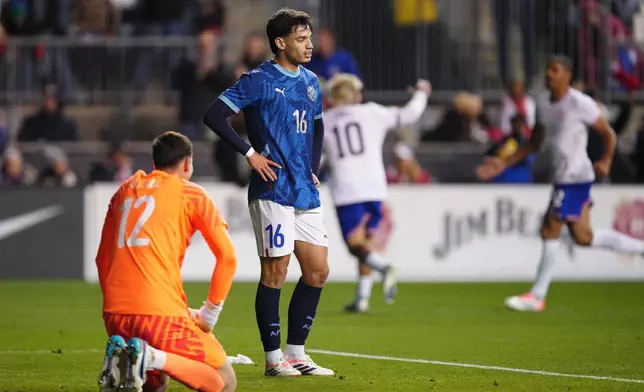Paraguay's Orlando Gill, left, and Damián Bobadilla (16) react after a goal scored by United States' Folarin Balogun during the second half of an international friendly soccer match, Saturday, Nov. 15, 2025, in Chester, Pa. (AP Photo/Derik Hamilton)
