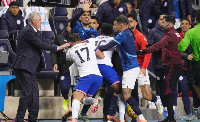 Paraguay's Gustavo Gomez (15), United States' Sebastian Berhalter (17) and Alex Freeman (16) and Paraguay's Antonio Sanabria scuffle on the sidelines during the second half of an international friendly soccer match, Saturday, Nov. 15, 2025, in Chester, Pa. (AP Photo/Derik Hamilton)