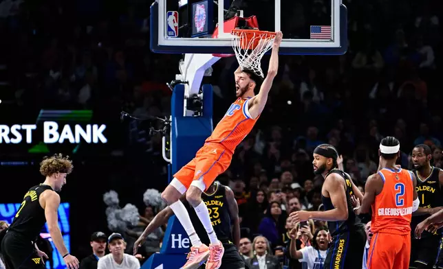 Oklahoma City Thunder center/forward Chet Holmgren (7) celebrates after a dunk against the Golden State Warriors during the first half of an NBA basketball game, Tuesday, Nov. 11, 2025, in Oklahoma City. (AP Photo/Gerald Leong)