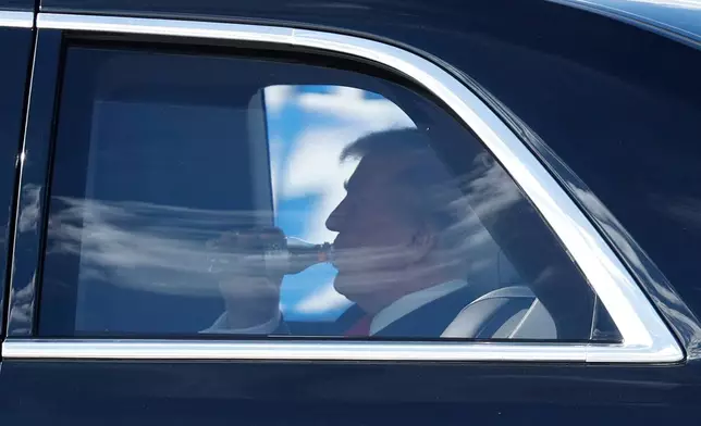 President Donald Trump is seen in his limousine, known as "The Beast," upon his arrival at Joint Base Andrews, Md., Friday, Oct. 31, 2025, en route to his Mar-a-Lago estate in Palm Beach, Fla. (AP Photo/Luis M. Alvarez)