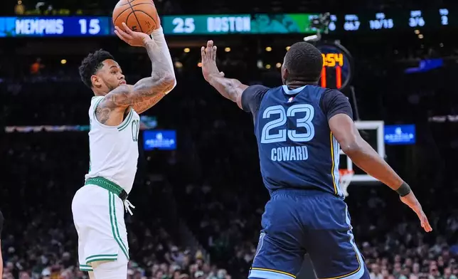 Boston Celtics guard Anfernee Simons, left, takes a 3-point shot against Memphis Grizzlies guard Cedric Coward (23) during the first half of an NBA basketball game, Wednesday, Nov. 12, 2025, in Boston. (AP Photo/Charles Krupa)
