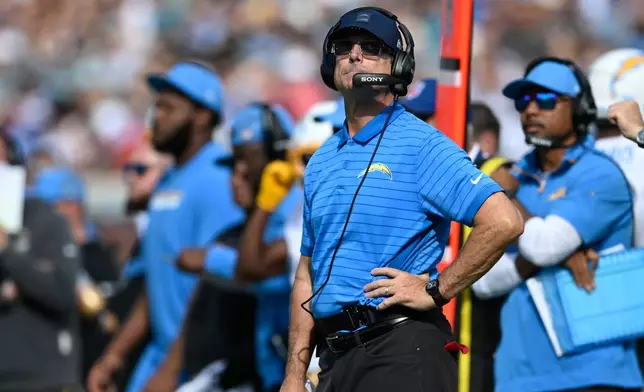 Los Angeles Chargers head coach Jim Harbaugh watches during the first half of an NFL football game against the Jacksonville Jaguars, Sunday, Nov. 16, 2025, in Jacksonville, Fla. (AP Photo/Phelan M. Ebenhack)