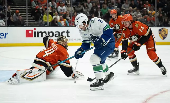 Vancouver Canucks right wing Conor Garland (8) scores past Anaheim Ducks goaltender Petr Mrazek (34) during the second period of an NHL hockey game, Wednesday, Nov. 26, 2025, in Anaheim, Calif. (AP Photo/Kyusung Gong)
