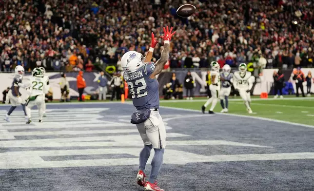 New England Patriots running back TreVeyon Henderson catches a touchdown pass during the second half of an NFL football game against the New York Jets, Thursday, Nov. 13, 2025, in Foxborough, Mass. (AP Photo/Charles Krupa)