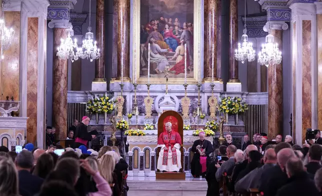 Pope Leo XIV listens as Archbishop Martin Kmetec of Izmir delivers his speech during a meeting with the clergy at the Cathedral of the Holy Spirit, in Istanbul, Turkey, Friday, Nov. 28, 2025. (AP Photo/Domenico Stinellis)