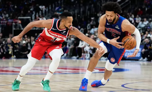 Detroit Pistons guard Cade Cunningham, right, steals the ball from Washington Wizards guard CJ McCollum during the first half of an NBA basketball game Monday, Nov. 10, 2025, in Detroit. (AP Photo/Ryan Sun)