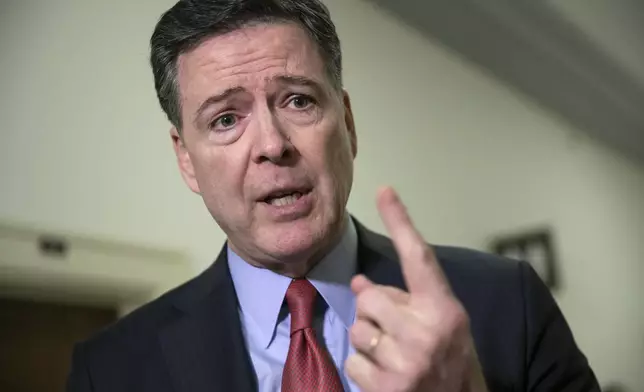 FILE - Former FBI Director James Comey speaks to reporters on Capitol Hill Washington, Dec. 17, 2018. (AP Photo/J. Scott Applewhite, File)
