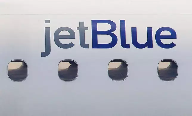 FILE - A JetBlue logo is displayed on the side of a jet as it taxis at Boston's Logan International Airport, Jan. 20, 2011. (AP Photo/Stephan Savoia, File)