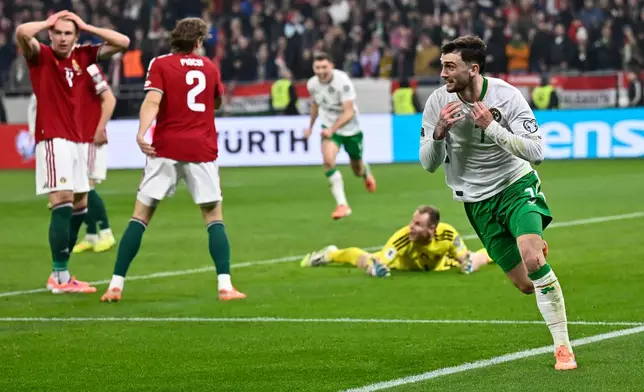 Ireland's Troy Parrott, right, celebrates after scoring his side's third goal during the World Cup 2026 group F qualifying soccer match between Hungary and Ireland in Budapest, Hungary, Sunday, Nov. 16, 2025. (AP Photo/Denes Erdos)