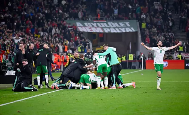 Ireland players celebrates after Ireland's Troy Parrott scored his side's third goal during the World Cup 2026 group F qualifying soccer match between Hungary and Ireland in Budapest, Hungary, Sunday, Nov. 16, 2025. (AP Photo/Denes Erdos)