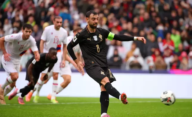 Portugal's Bruno Fernandes scores his side's seventh goal from the penalty spot during a World Cup 2026 group F qualifying soccer match between Portugal and Armenia in Porto, Portugal, Sunday, Nov. 16, 2025. (AP Photo/Luis Vieira)