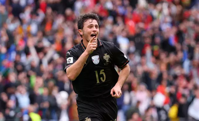 Portugal's Joao Neves celebrates after scoring his side's fourth goal during a World Cup 2026 group F qualifying soccer match between Portugal and Armenia in Porto, Portugal, Sunday, Nov. 16, 2025. (AP Photo/Luis Vieira)