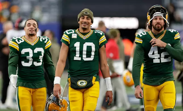 Green Bay Packers' Evan Williams, Jordan Love and Matt Orzech smile as they walk off the field after an NFL football game against the New York Giants Sunday, Nov. 16, 2025, in East Rutherford, N.J. (AP Photo/Adam Hunger)