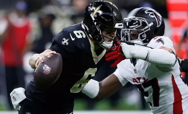 New Orleans Saints quarterback Tyler Shough (6) is sacked by Atlanta Falcons linebacker James Pearce Jr. in the second half of an NFL football game, Sunday, Nov. 23, 2025, in New Orleans. (AP Photo/Butch Dill)