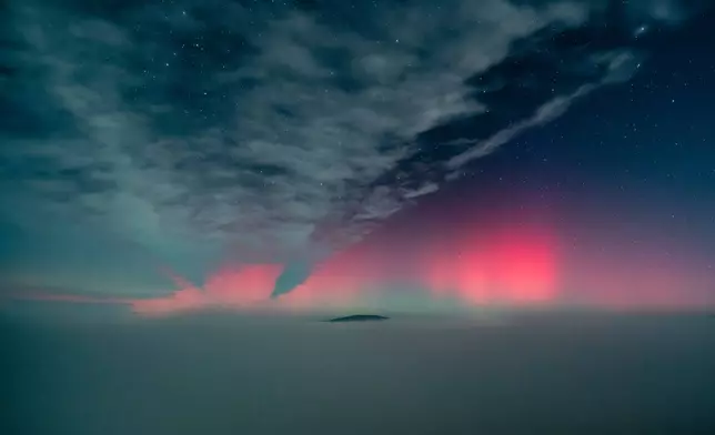 The northern lights (aurora borealis) fill the sky as it is seen from Salgotarjan, northern Hungary, early Wednesday, Nov. 12, 2025. (Peter Komka/MTI via AP)