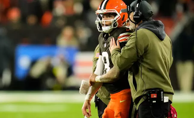 Cleveland Browns quarterback Dillon Gabriel (8) talks with head coach Kevin Stefanski on the sideline in the first half of an NFL football game against the Baltimore Ravens in Cleveland, Sunday, Nov. 16, 2025. (AP Photo/Sue Ogrocki)