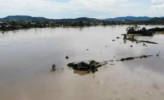 This aerial photo shows a building submerged in flooding in Dak Lak, Vietnam on Friday, Nov. 7, 2025 after Typhoon Kalmaegi lashed Vietnam with fierce winds and torrential rains. (AP Photo/Hau Dinh)