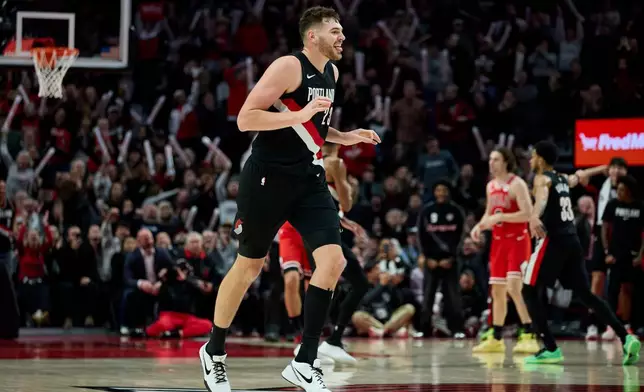 Portland Trail Blazers center Donovan Clingan reacts after making a three-point basket against the Chicago Bulls during the second half of an NBA basketball game in Portland, Ore., Wednesday, Nov. 19, 2025. (AP Photo/Craig Mitchelldyer)
