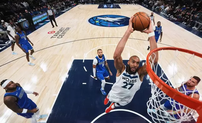 Minnesota Timberwolves center Rudy Gobert (27) goes up to dunk during the second half of an NBA basketball game against the Dallas Mavericks, Monday, Nov. 17, 2025, in Minneapolis. (AP Photo/Abbie Parr)