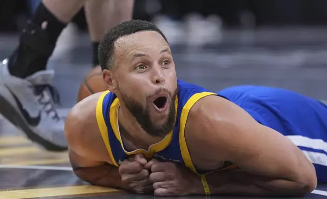 Golden State Warriors guard Stephen Curry (30) reacts after he was fouled during the second half of an NBA Cup basketball game against the San Antonio Spurs in San Antonio, Friday, Nov. 14, 2025. (AP Photo/Eric Gay)