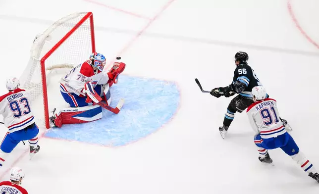Utah Mammoth right wing Kailer Yamamoto (56) shoots the puck past Montréal Canadiens goaltender Jakub Dobes (75) for a goal during the second period of an NHL hockey game, Wednesday, Nov. 26, 2025, in Salt Lake City. (AP Photo/Tyler Tate)