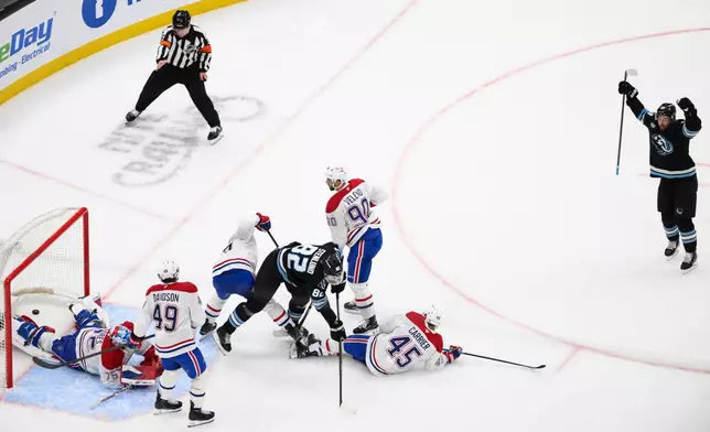 Utah Mammoth left wing Michael Carcone, right, celebrates scoring a goal during the second period of an NHL hockey game against the Montréal Canadiens, Wednesday, Nov. 26, 2025, in Salt Lake City. (AP Photo/Tyler Tate)