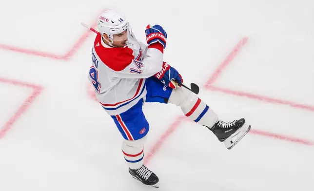 Montréal Canadiens center Nick Suzuki celebrates scoring a goal during the third period of an NHL hockey game against the Utah Mammoth, Wednesday, Nov. 26, 2025, in Salt Lake City. (AP Photo/Tyler Tate)