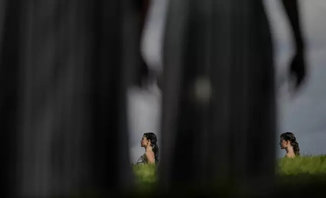 Dancers playing the role of priestesses perform during a rehearsal ahead of the flame lighting for the Milan Cortina 2026 Winter Olympics, at the Ancient Olympia site, Greece, Monday, Nov. 24, 2025. (AP Photo/Petros Giannakouris)