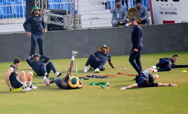 South Africa's Nandre Burger, left, and teammates warm up before a practice session, in Faisalabad, Pakistan, Monday, Nov. 3, 2025. (AP Photo/Anjum Naveed)