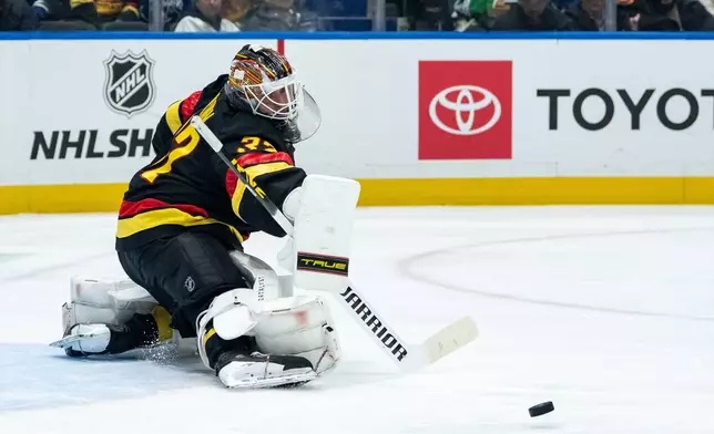 Vancouver Canucks goaltender Kevin Lankinen stops the puck against the Dallas Stars during the second period of an NHL hockey game in Vancouver, British Columbia, Thursday, Nov. 20, 2025. (Ethan Cairns/The Canadian Press via AP)
