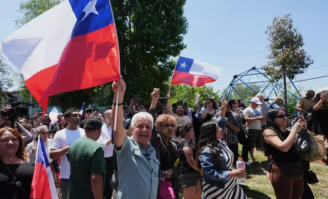 Supporters of presidential candidate Jeannette Jara of the Unidad por Chile coalition cheer outside the polling station before her arrival during general elections in Santiago, Chile, Sunday, Nov. 16, 2025. (AP Photo/Natacha Pisarenko)