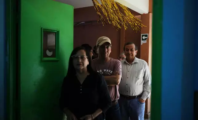 Voters line up at a polling station during general elections in Santiago, Chile, Sunday, Nov. 16, 2025. (AP Photo/Natacha Pisarenko)