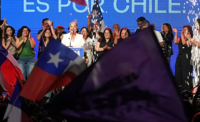 Presidential candidate Jeannette Jara of the Unidad por Chile coalition, center left, addresses supporters after early results in the general elections in Santiago, Chile, Sunday, Nov. 16, 2025. (AP Photo/Natacha Pisarenko)